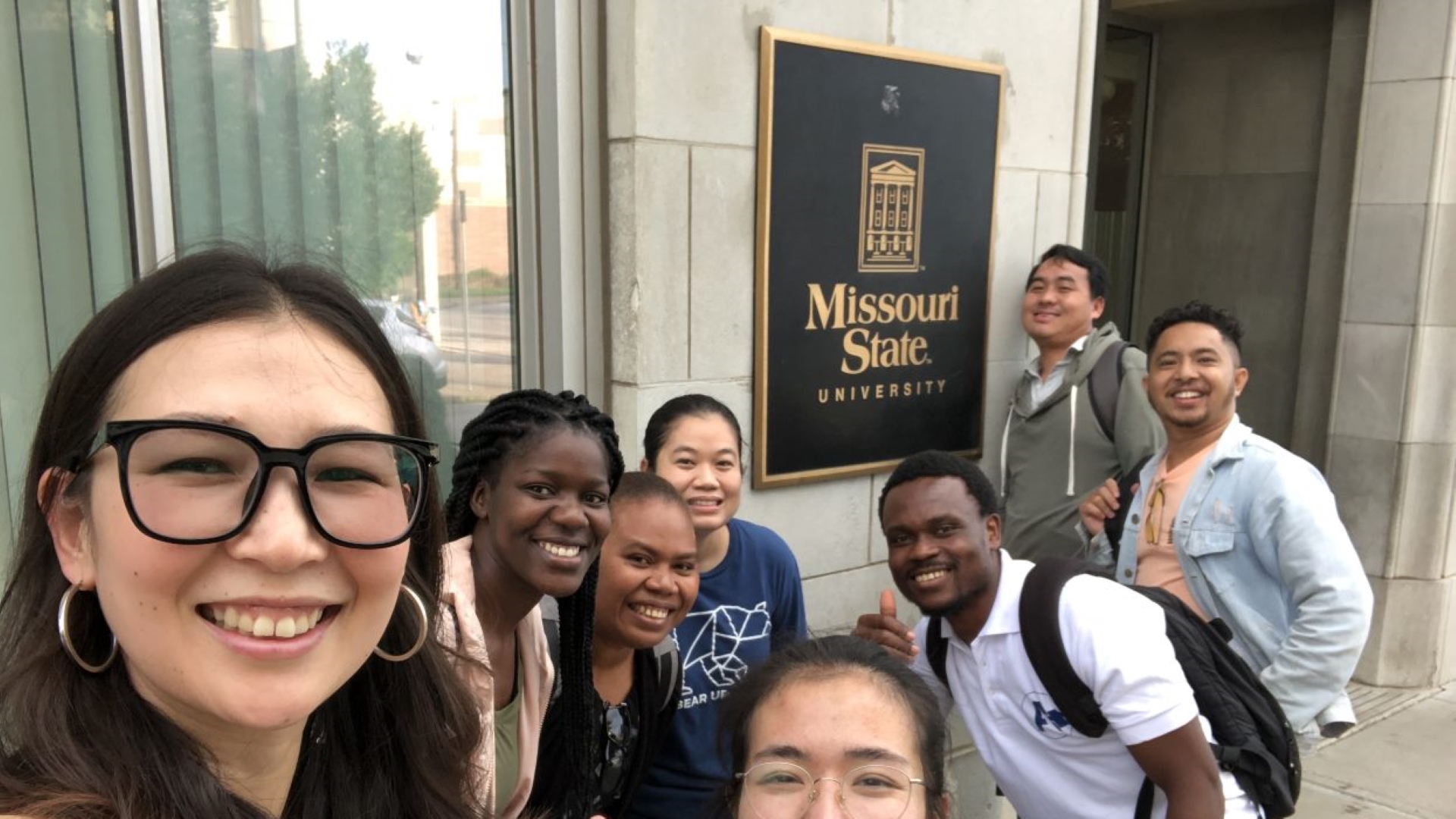Diverse group of ELI students in front Morris Center building