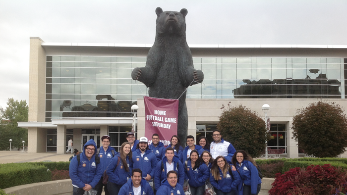 students posing with the bear in front of Plaster Student Union