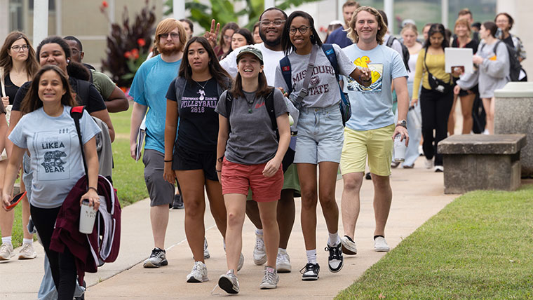 Students walking on campus for new international student orientation